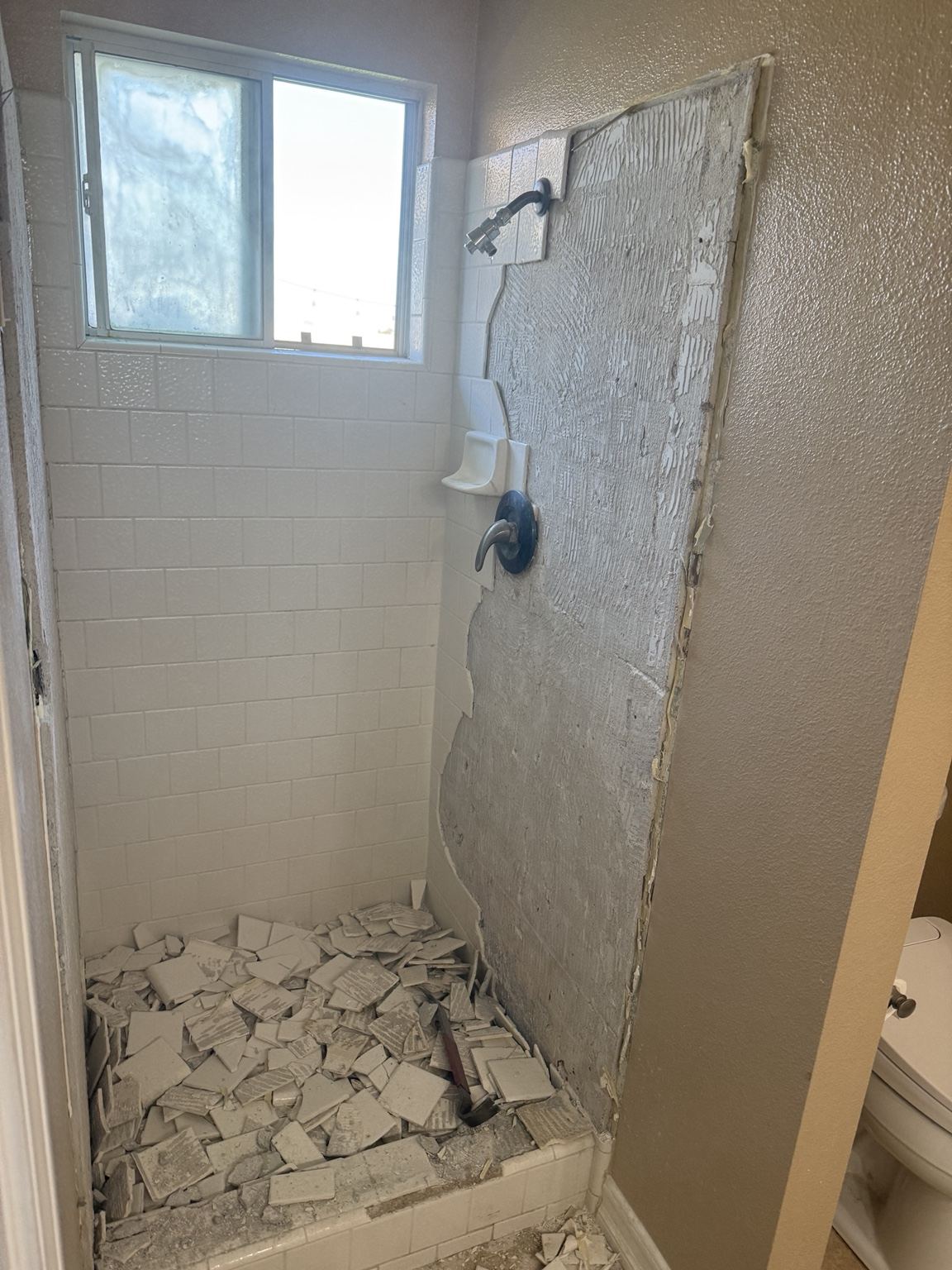 Original shower during demolition