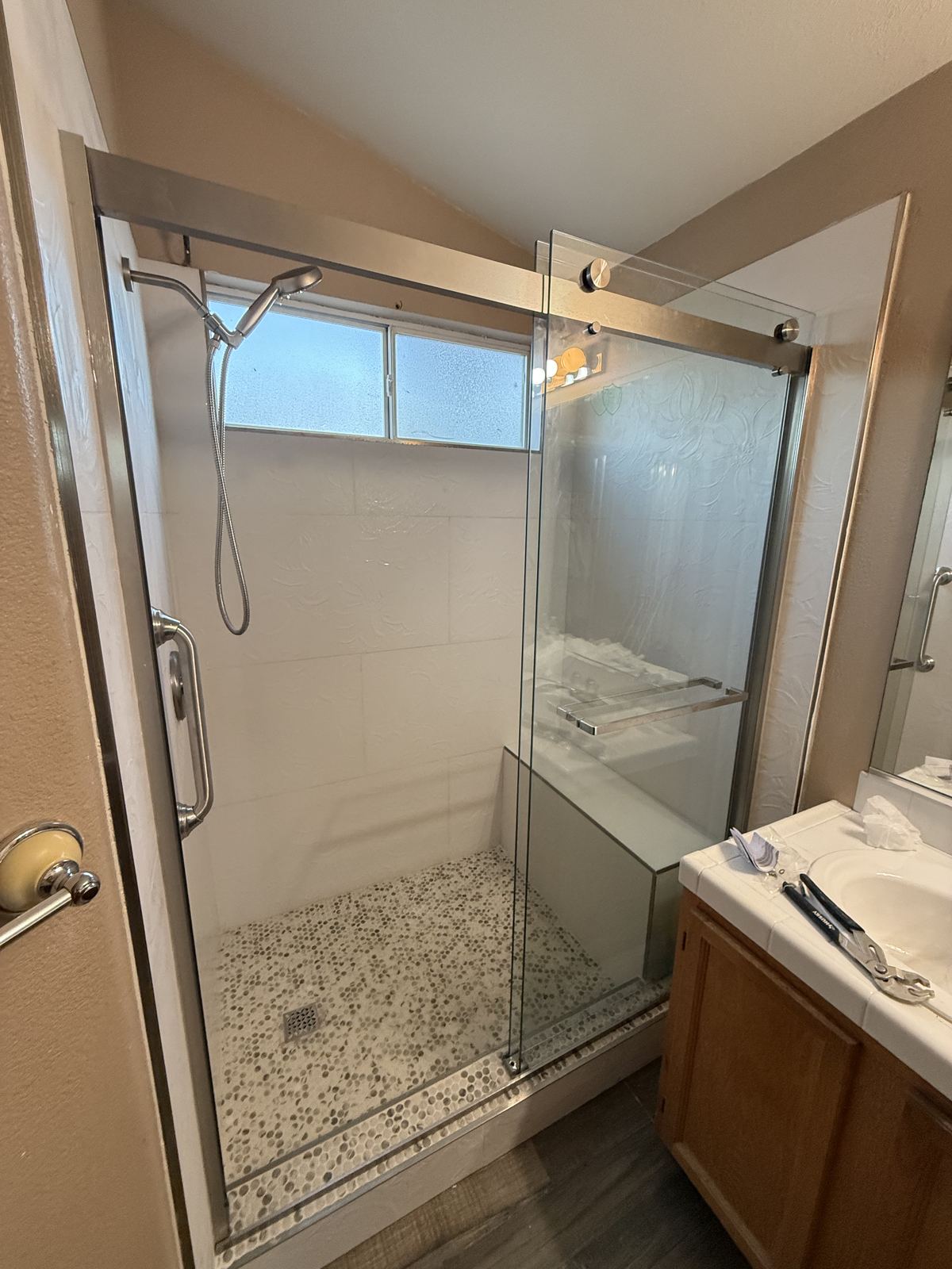 Finished walk-in shower with frameless sliding glass